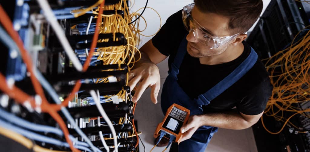 Network engineer checking telephone and network cables